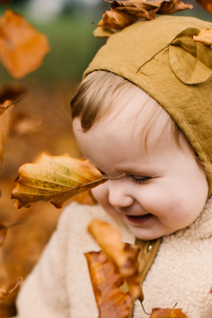 Happy kid in autumn leaves